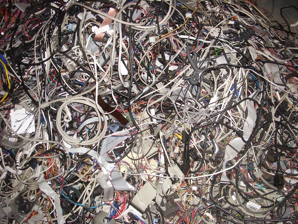 A pile of tangled computer cables.